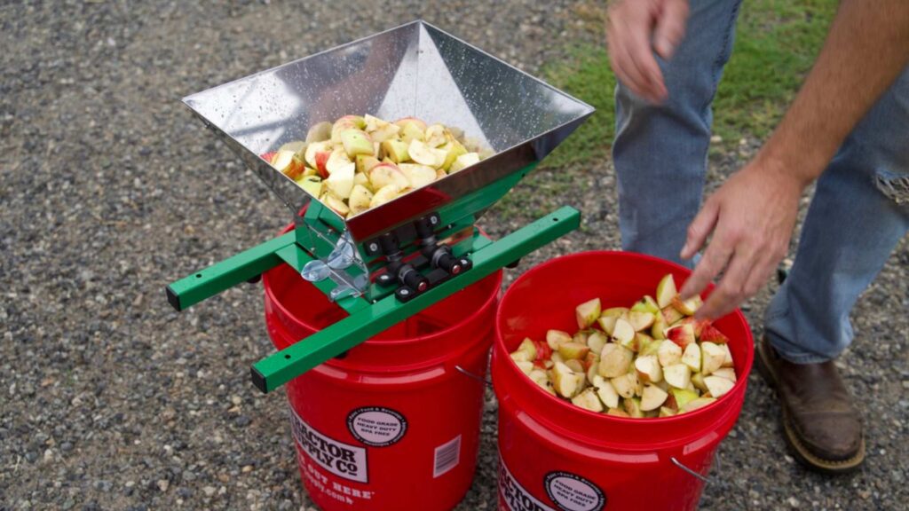 chopped apples going into a fruit crusher
