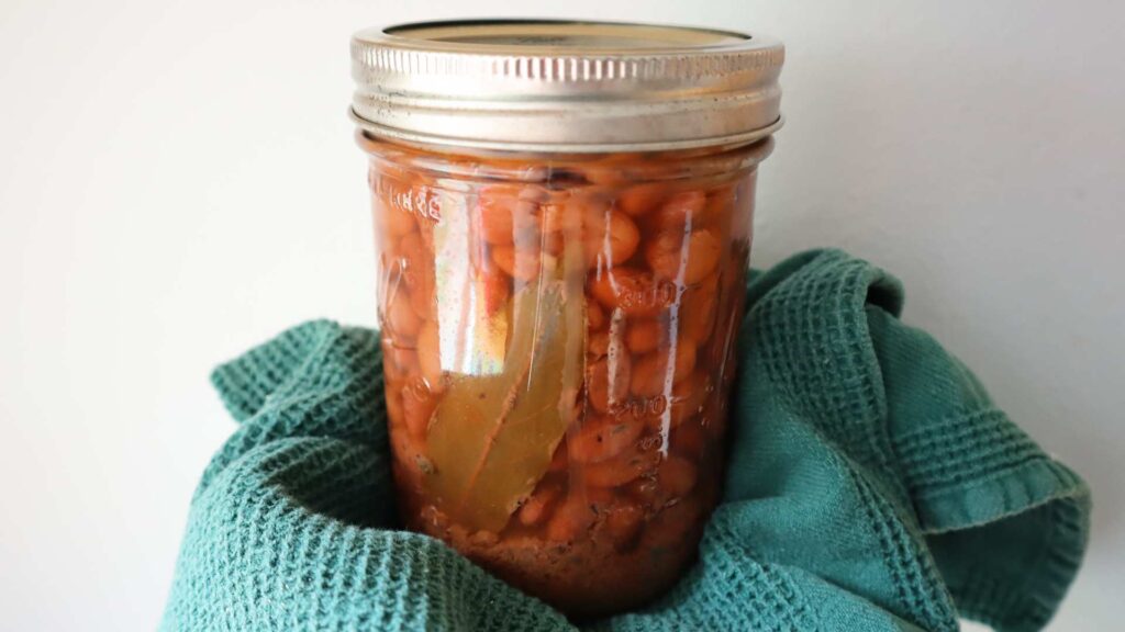 Closeup of pint jar of Mexican spiced pressure canned pinto beans.