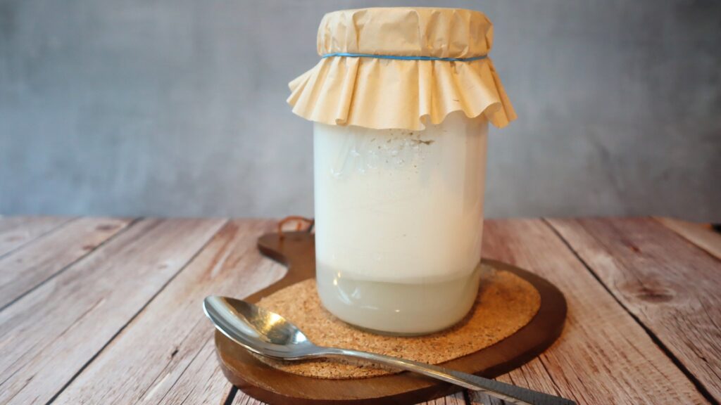 Coconut kefir fermenting, coconut water separating from the coconut fat