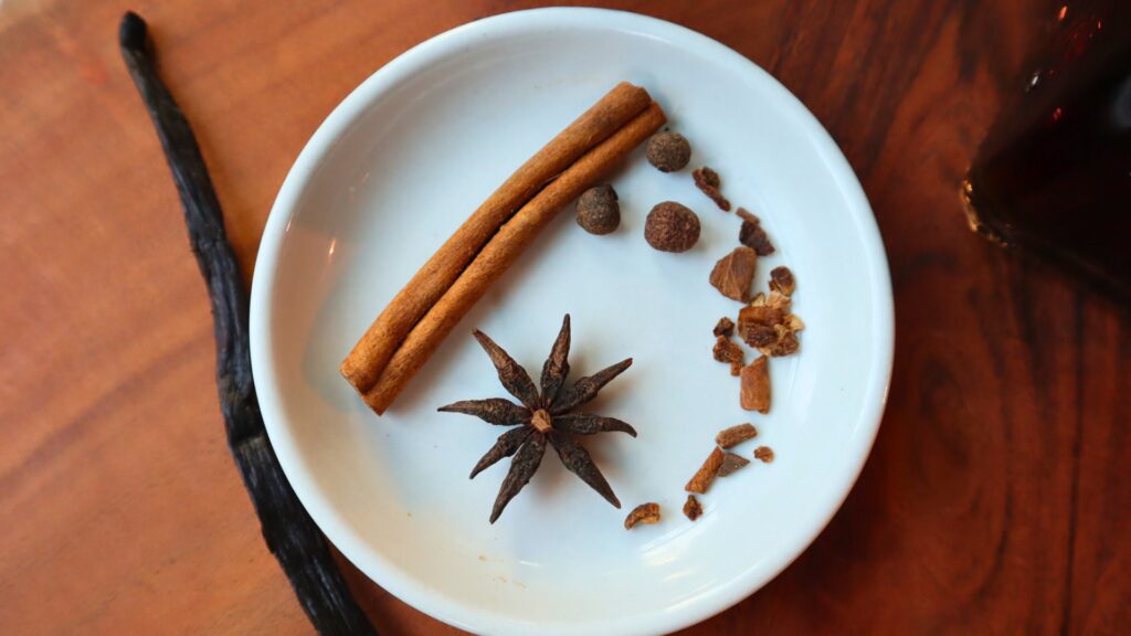 Closeup of whole spices of cinnamon, anise and allspice berries.