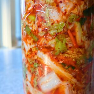 Close up of kimchi in a jar.